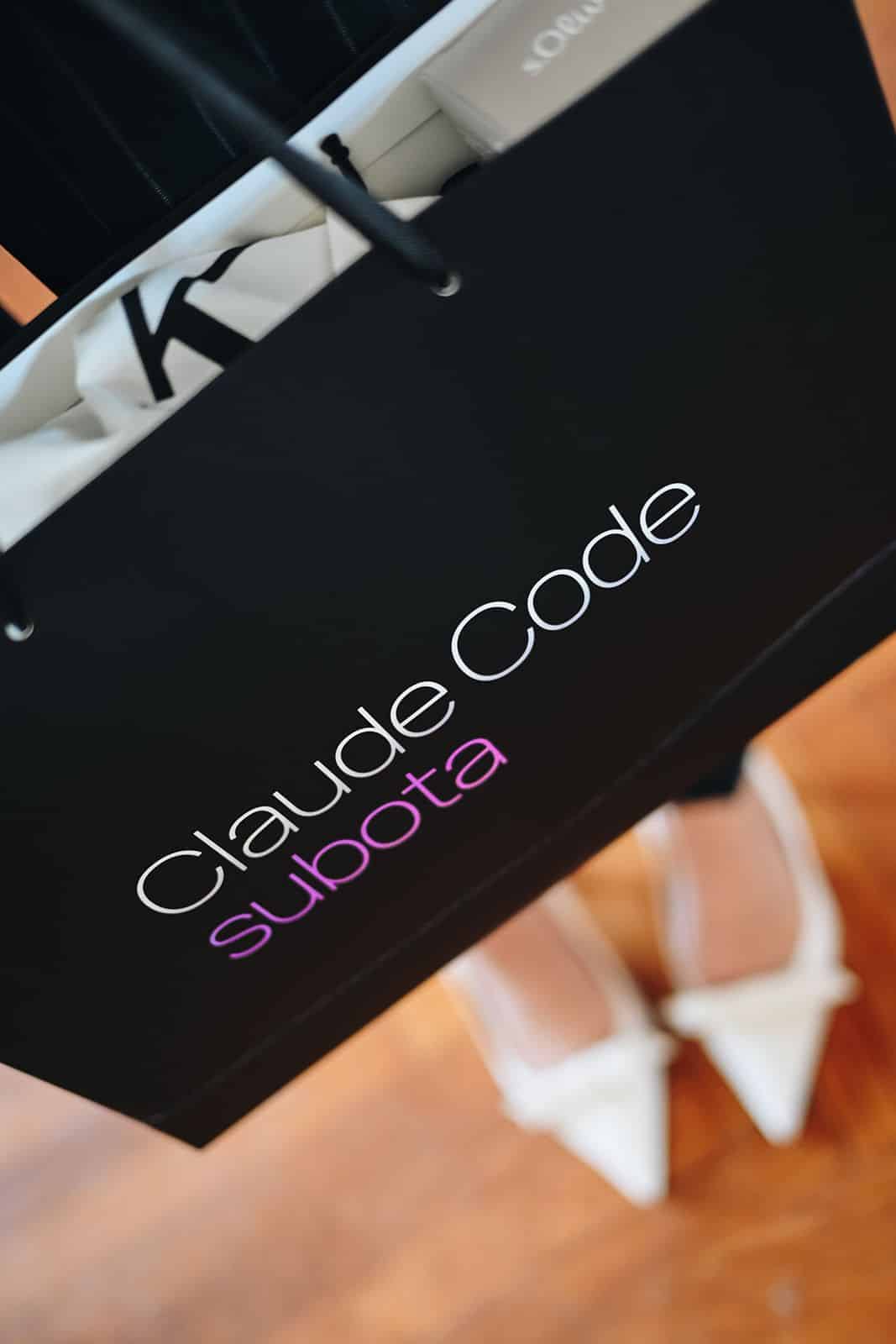 A Claude Code Saturday bag beside shoes on the parquet