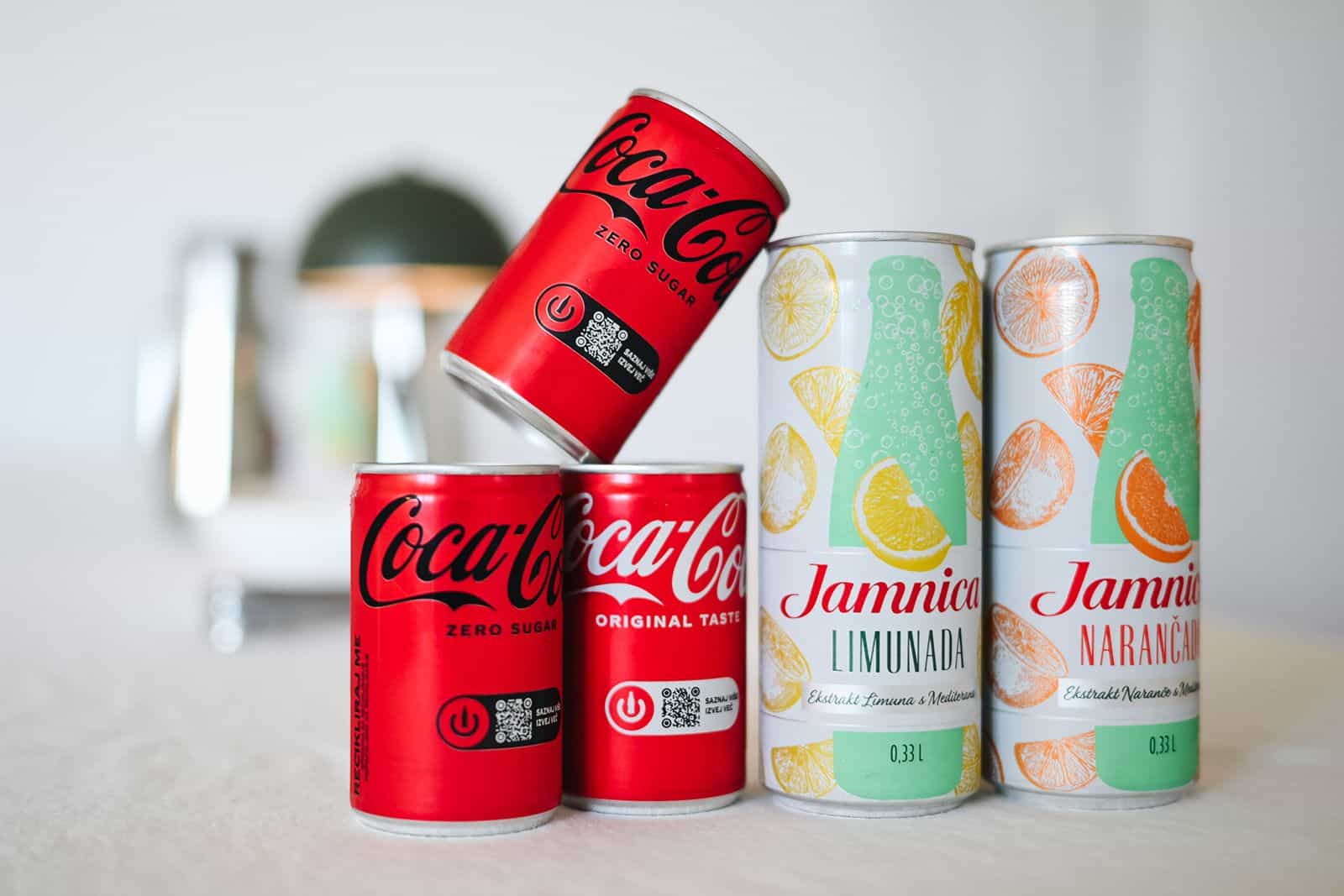 Cans of Coca-Cola and Jamnica on the table