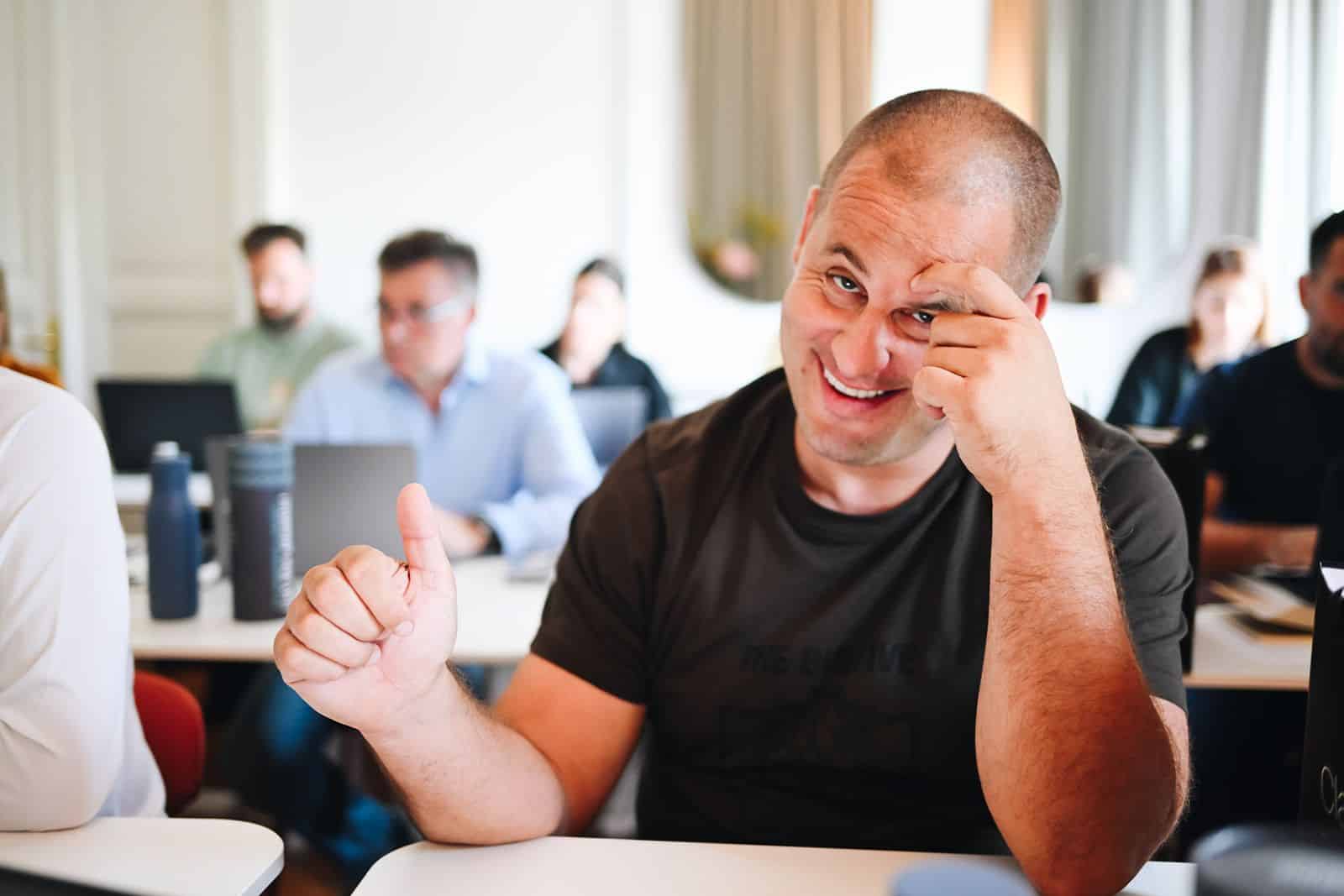 A participant laughs and gives a thumbs up