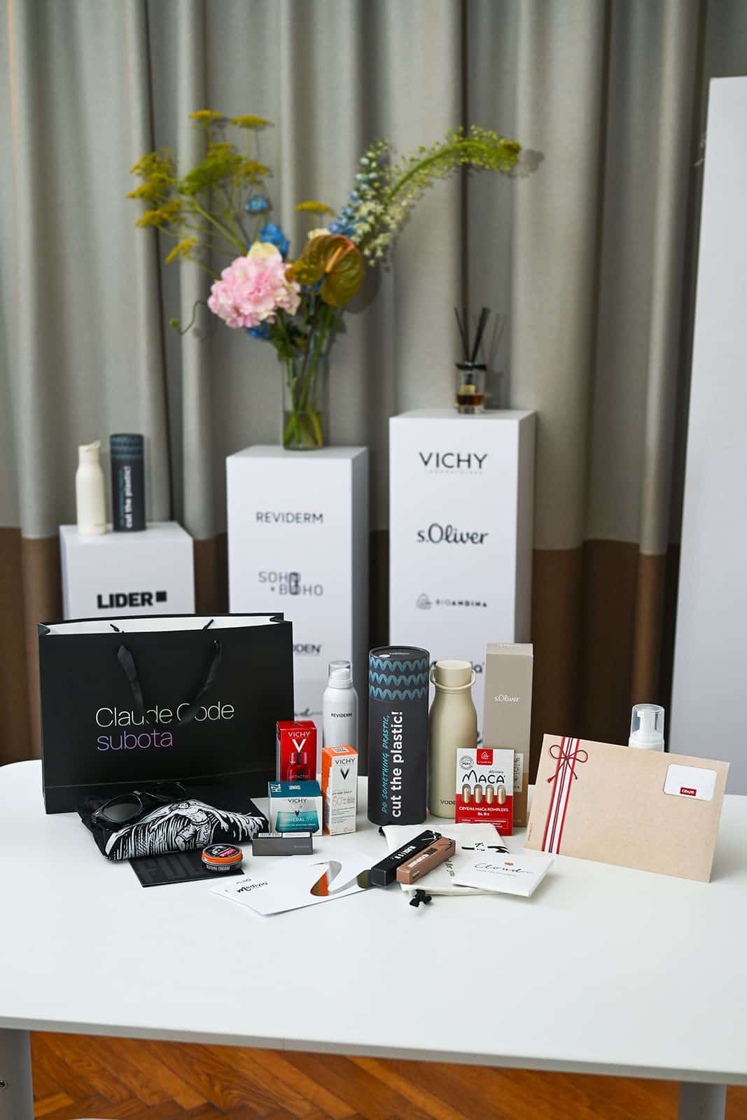 The contents of the Claude Code Saturday gift bag laid out on a table