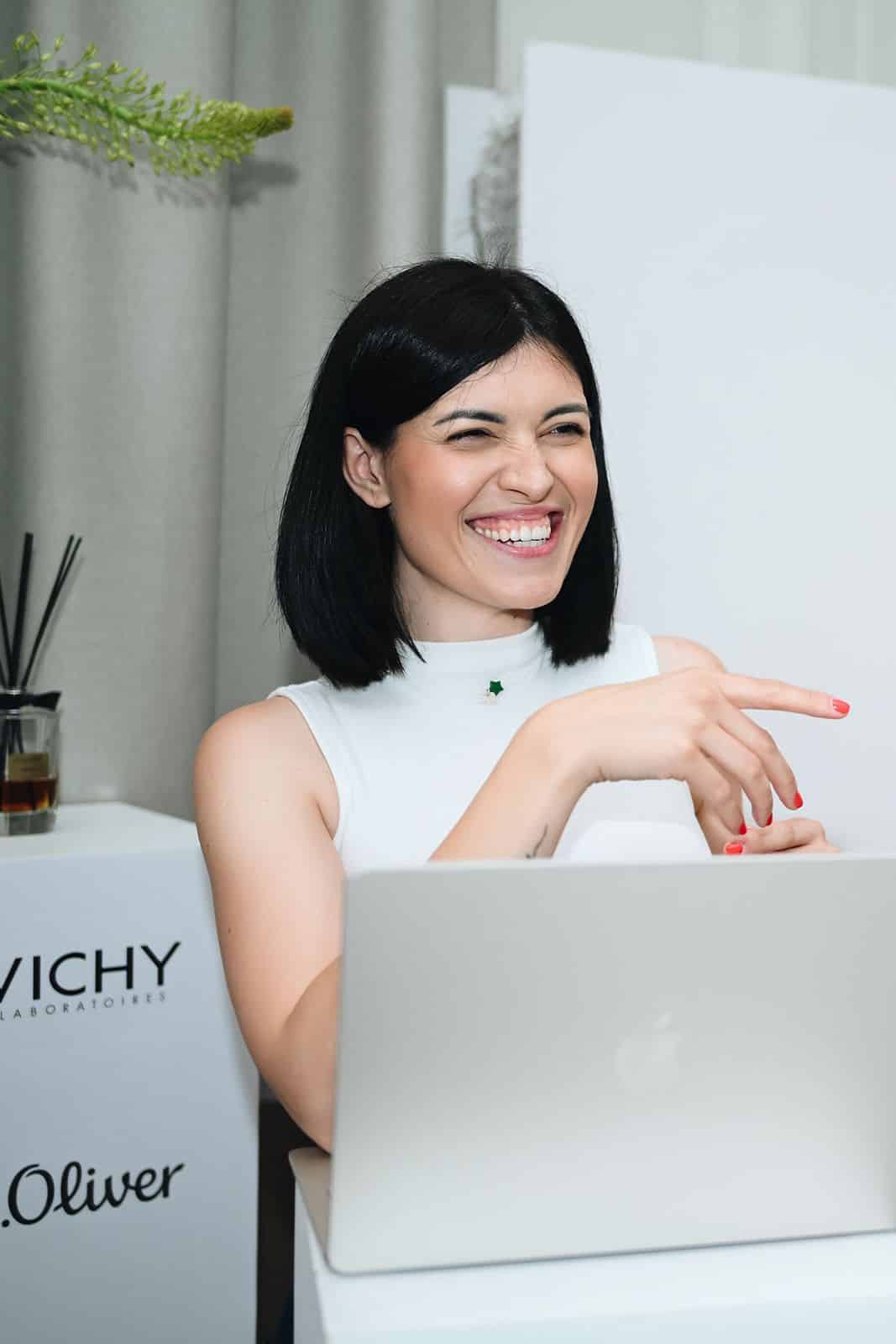Patricija Topić laughs and points at a laptop screen