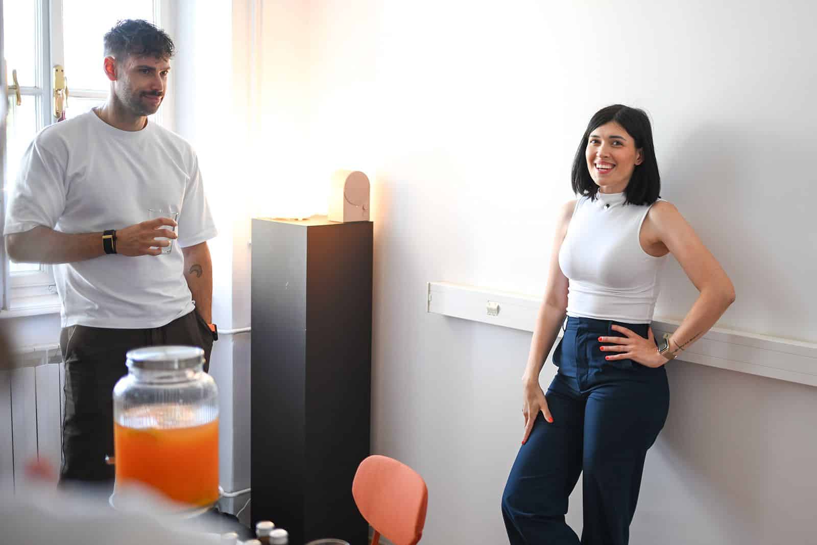 Two participants talk by the window