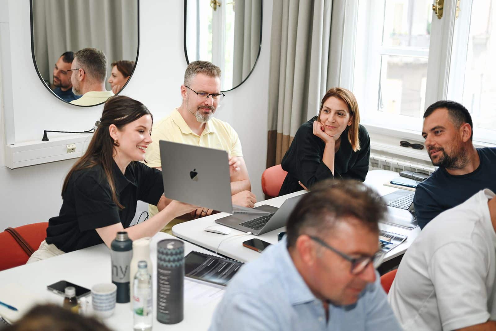 Participants gathered around a laptop, looking at the result
