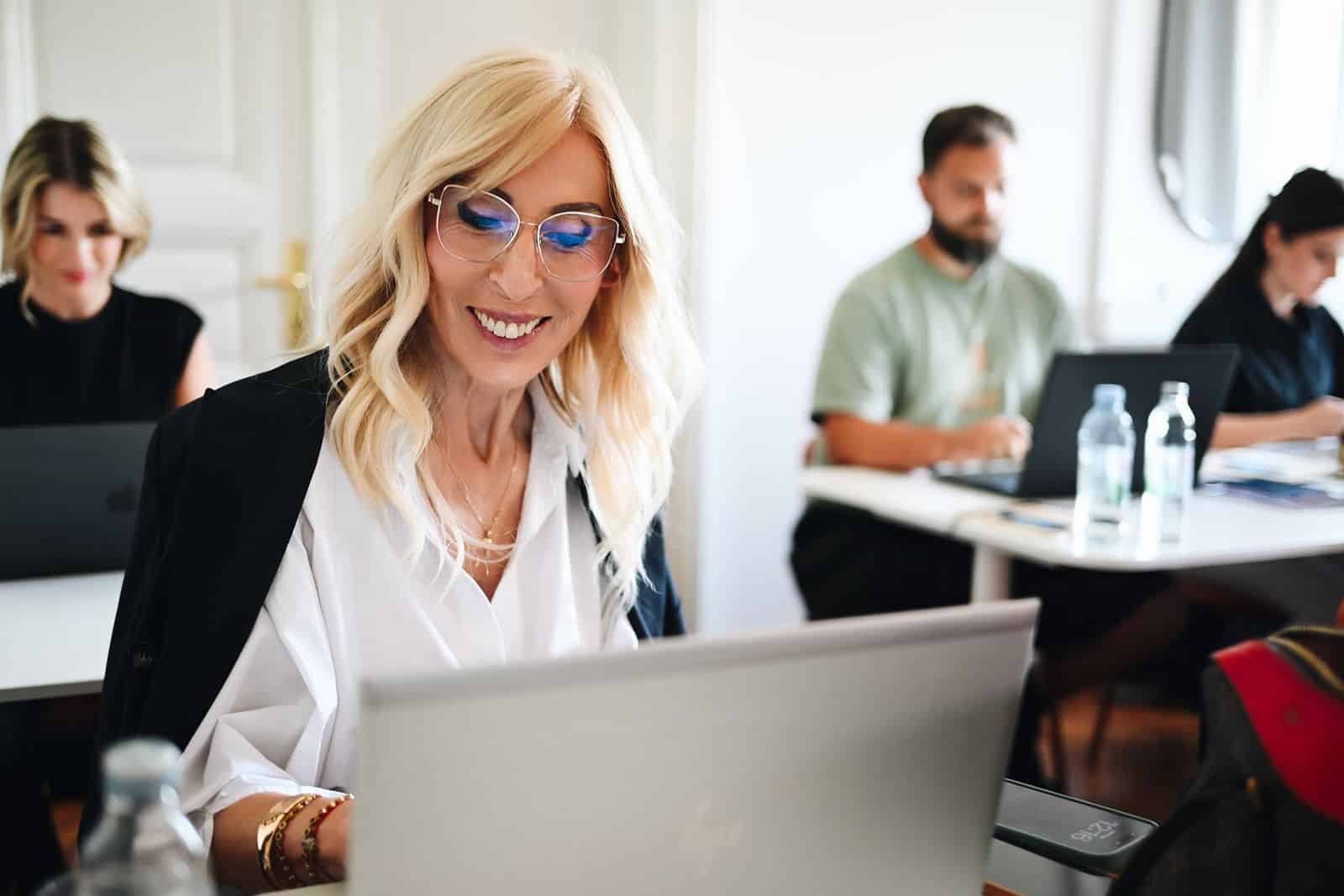 A participant laughs at the laptop while working