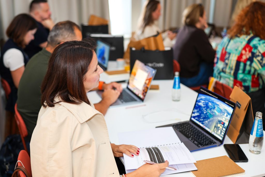 A participant working in Claude Code on her laptop