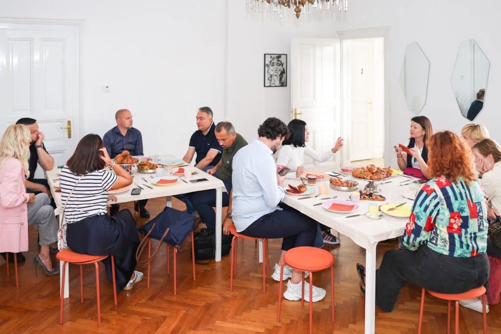 Participants of Claude Code Saturday having breakfast and getting to know each other at the shared table